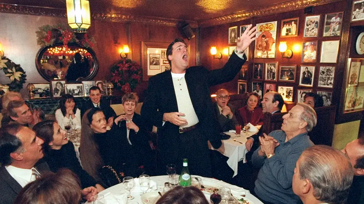 A singer performs for diners in the wood-paneled dining room at Rao's